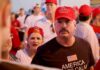 Darren Balsley in a red cap at a crowded outdoor event