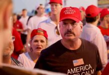Darren Balsley in a red cap at a crowded outdoor event
