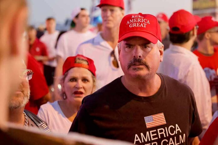 Darren Balsley in a red cap at a crowded outdoor event