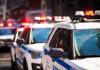 police cars with flashing lights on a city street