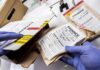 Explosive Allegation Puts Markle Under Scrutiny Gloved hands handling labeled evidence bags and boxes