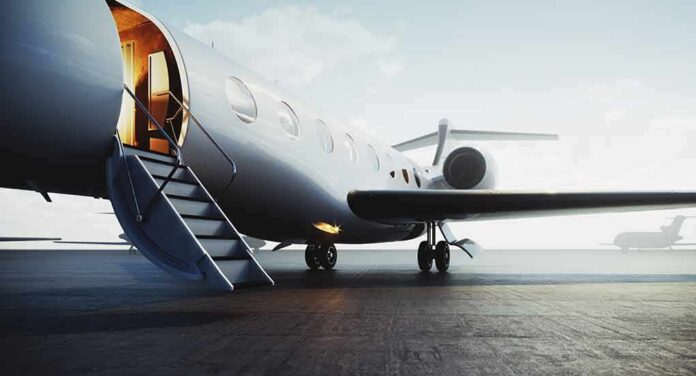 Private jet on tarmac with open door and boarding stairs