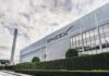 SpaceX headquarters exterior with rocket booster and hedge