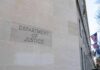 Department of Justice building exterior with American flags