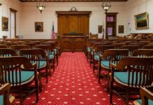 Courtroom with wooden benches facing the judge's bench