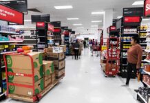 Interior of a grocery store with shelves filled with products and shoppers