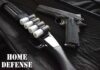 Shotgun and handgun on a black case