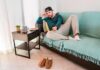 He Watched Football – Cops Got Called Man lounging on a sofa with remote control