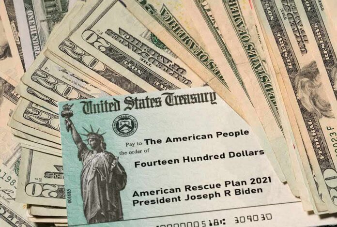 U.S. Treasury check on top of scattered dollar bills