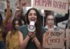 Young woman leading a protest with a megaphone
