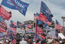 German Giant Picks Georgia Over Europe Crowd at political rally with many American and campaign flags