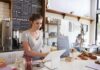 Barista using a tablet register at a cafe counter