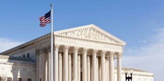 United States Supreme Court building with American flag.
