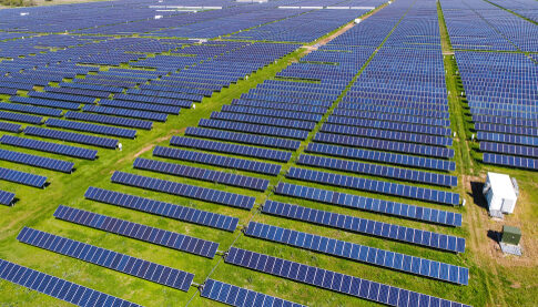 Aerial view of an expansive solar panel farm.