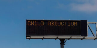 Highway sign displaying "CHILD ABDUCTION" message.
