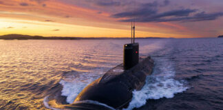 Submarine sailing at sunset in the ocean.