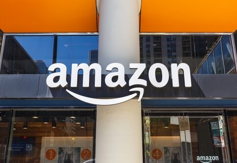 Amazon logo displayed on a storefront with an orange awning
