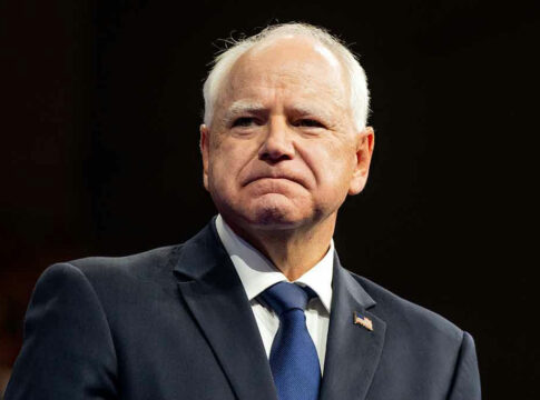 Man in suit with American flag pin.