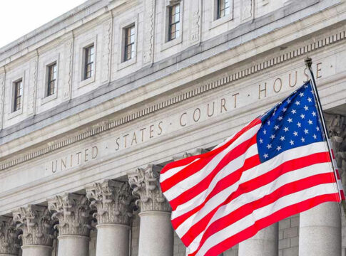 United States courthouse with American flag waving.