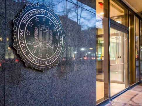 FBI seal on building wall near entrance doors.