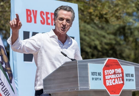 Gavin Newsom speaking at a podium, Stop the Republican Recall.