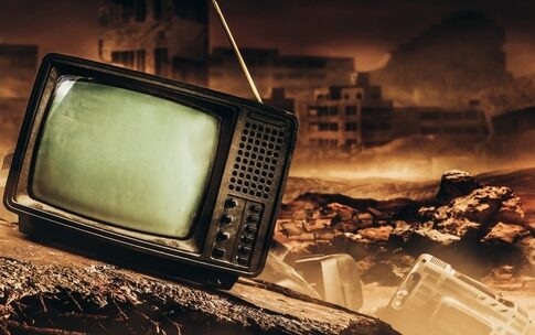 An old, broken television set in a desolate, post-apocalyptic landscape