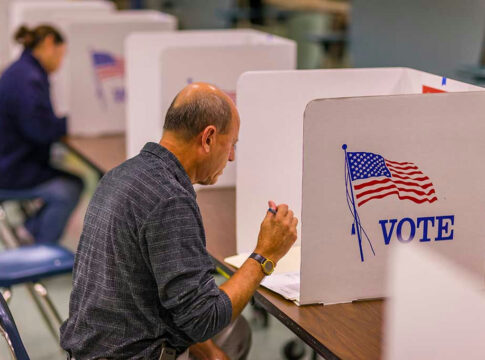 Person voting in a polling booth.