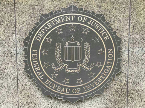 Department of Justice, FBI seal on stone background.
