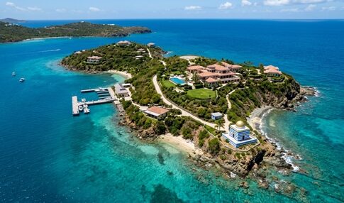 Aerial view of a tropical island with luxury villas and clear blue waters